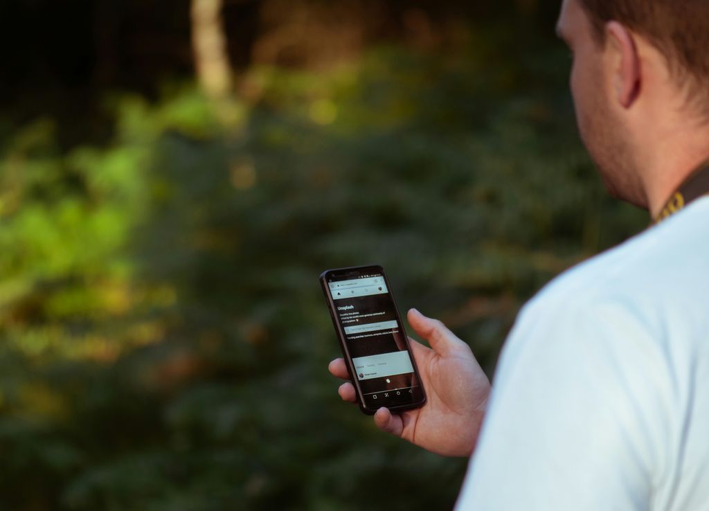 Person filmt mit einem Smartphone auf einem Gimbal eine Szene im Freien